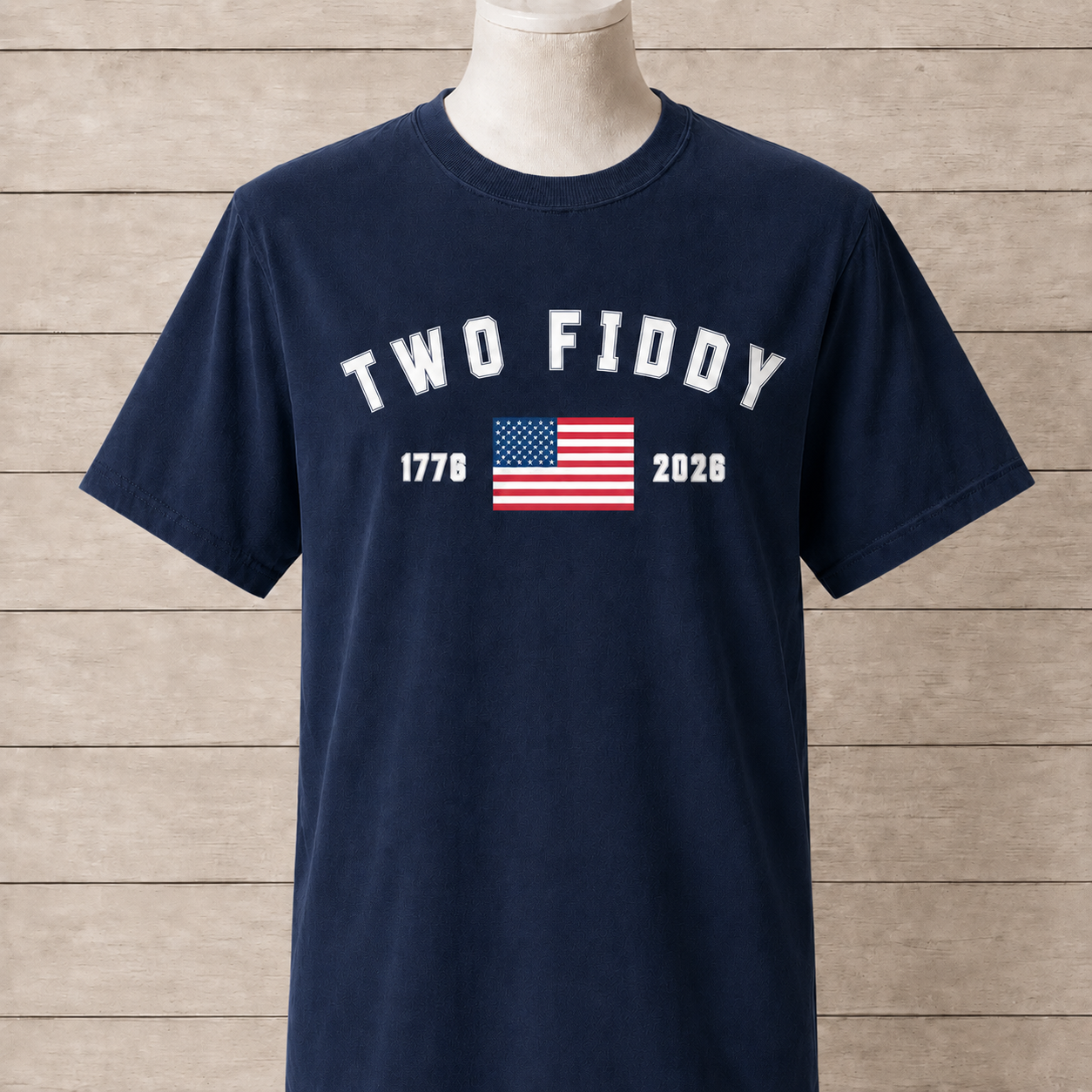 Navy blue t-shirt with 'TWO FIDDY' text and American flag on a wooden background